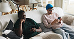 Relax, phone and scroll with friends on sofa of home for social media, post comment or like update. Text message, reunion or online browsing with men in living room of apartment for communication app