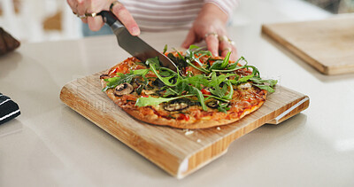 Buy stock photo Cooking, knife and hands of person with pizza in kitchen for dinner, lunch or meal in home. Food, nutrition and cutting dish for slice with preparing supper on counter with ingredients in house.