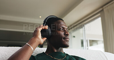 Buy stock photo Home, headphones and black man on couch, thinking and listening to music, sound and podcast. Playlist album, relax and African person on sofa, audio and radio with contemplation and daydreaming