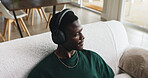 Above, headphones or black man on sofa, thinking or listening to music, daydreaming or podcast. Playlist album, home or African person with audio, sound or radio with contemplation or relax in lounge