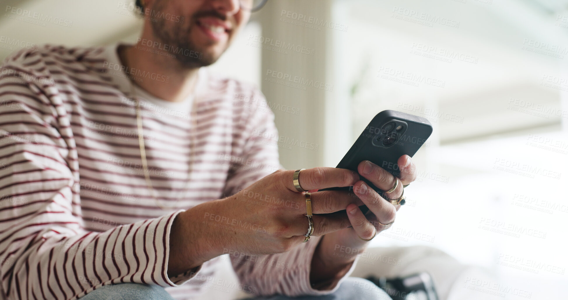 Buy stock photo Hands, phone and man on sofa in home with social media, contact or scrolling for networking. Notification, tech and male person with cellphone for connectivity, online or mobile app in living room