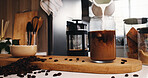 Pouring, cream and ice coffee preparation in kitchen, beans and ingredients for caffeine and liquid. Making, cold beverage and drink with antioxidants in glass, mixing and process with milk in house