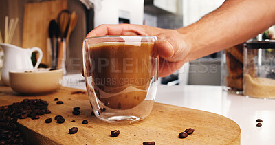 Buy stock photo Hand, beans and glass of coffee in kitchen in home for morning brew for energy boost drink. Ingredients, espresso and person with caffeine beverage for latte in mug for liquid on counter in apartment