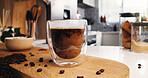 Coffee, glass and drink in kitchen for strong caffeine, pour or roast in home. Organic brew, beans and blend with cappuccino for mocha, espresso or breakfast beverage in house for morning preparation