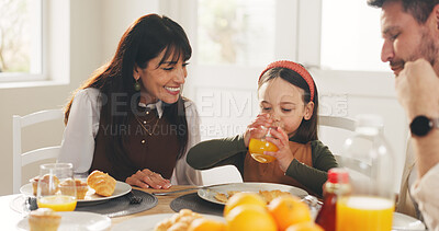 Buy stock photo Breakfast, drinking and juice with happy family in dining room of home together for meal or nutrition. Beverage, food or smile with mother, father and daughter in apartment for diet, health or hunger