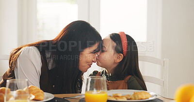 Buy stock photo Happy mom, child and kiss with breakfast in home for love, care or bonding together on dining table. Mother, kid or daughter with orange juice or croissant for embrace, morning meal or family time