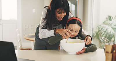 Buy stock photo Baking, mother or girl with mixing bowl on kitchen counter, meal prep or help with dessert in family home. Learning, laptop and happy woman with child to teaching cooking skills, guidance or support