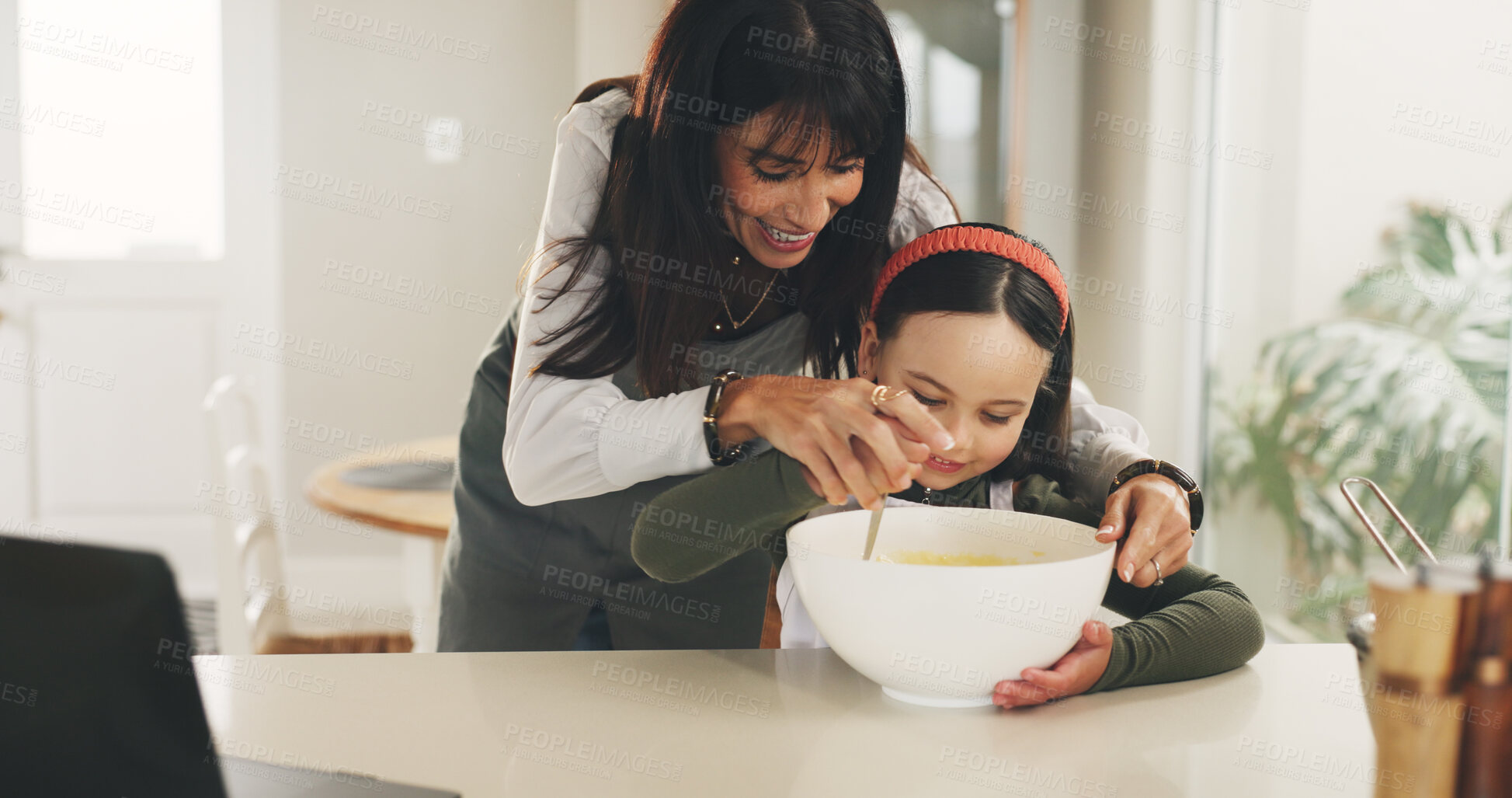 Buy stock photo Baking, mother or girl with mixing bowl on kitchen counter, meal prep or help with dessert in family home. Learning, laptop and happy woman with child to teaching cooking skills, guidance or support
