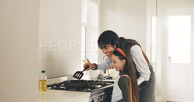 Buy stock photo Cooking, learning or spatula with mom and daughter in kitchen of home for bonding or development. Pan, stove or teaching with girl child and single parent woman in apartment for recipe instructions