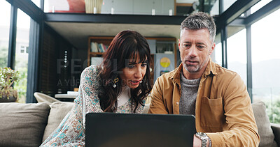 Buy stock photo Couple, reading and couch with laptop at house for finance, review budget and online payment. Mature people, pc and information on household expenses, financial savings and loan application for bills