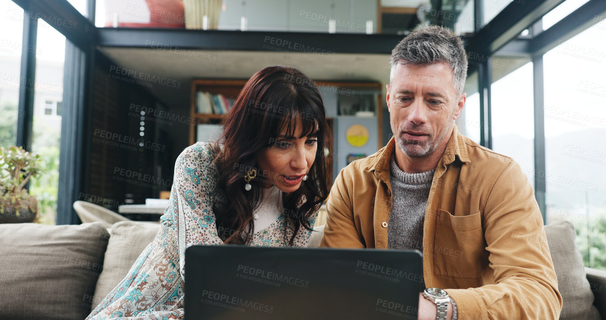 Buy stock photo Couple, reading and couch with laptop at house for finance, review budget and online payment. Mature people, pc and information on household expenses, financial savings and loan application for bills