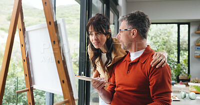 Buy stock photo Easel, couple and support with painting in home for creative activity, self expression and hug. Marriage, mature people or talking with canvas for custom art, exhibition project or bonding with hobby