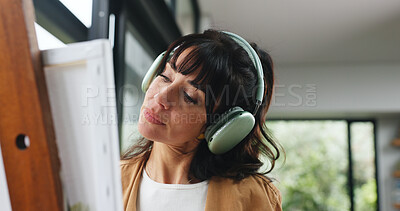 Buy stock photo Painting, headphones or woman in home with hobby, streaming or music inspiration for artwork. Creative outlet, tech or mature artist in house with canvas, radio or craft podcast for visual expression
