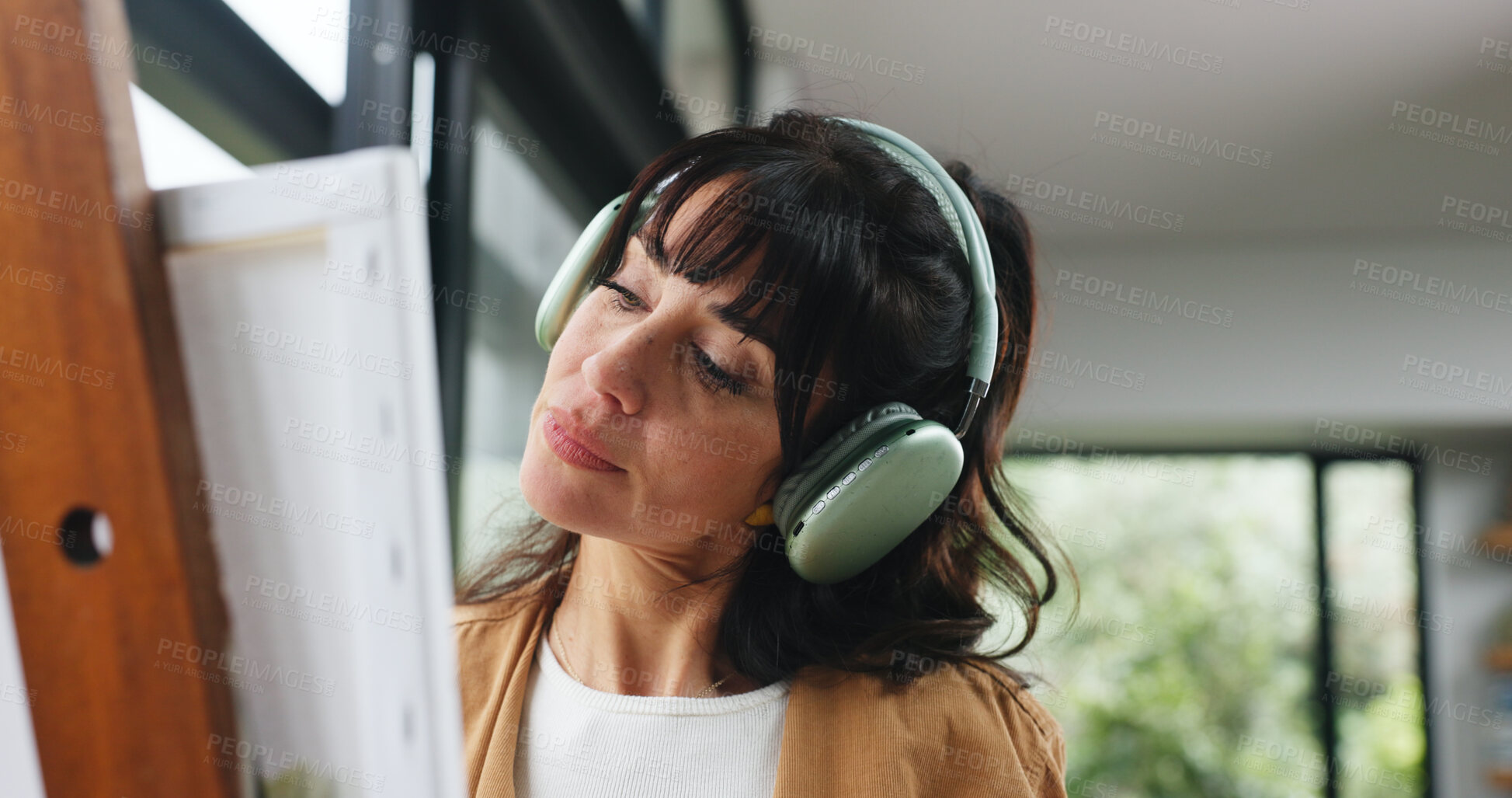 Buy stock photo Painting, headphones or woman in home with hobby, streaming or music inspiration for artwork. Creative outlet, tech or mature artist in house with canvas, radio or craft podcast for visual expression