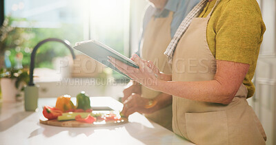 Buy stock photo Couple, hands or tablet with online cooking tutorial for healthy recipe or tips in kitchen. Apron, man and woman with tech, ingredients or research for diet, natural organic food or meal prep in home