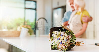 Buy stock photo Bouquet, flowers and hug with old couple in kitchen of home for anniversary celebration, romance and gift. Love, present and partner with senior man and woman in house for date and commitment