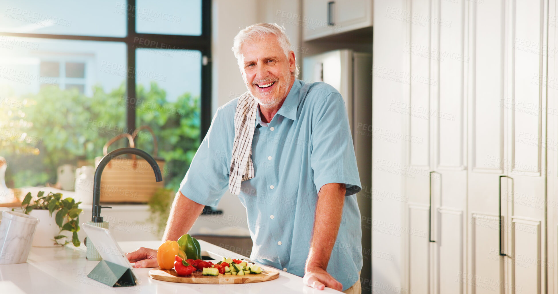 Buy stock photo Old man, tablet and happy in kitchen with portrait, recipe and online course for dinner at house. Person, vegetables and ingredients in retirement with tech, smile or confident for cooking in Spain