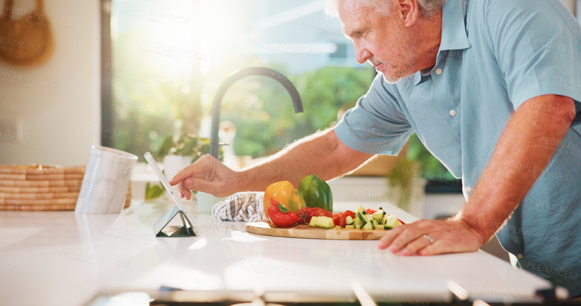 Buy stock photo Senior man, tablet and cooking in kitchen with search, recipe and online course for dinner at house. Person, vegetables and ingredients with food, app or tutorial video on web in retirement home