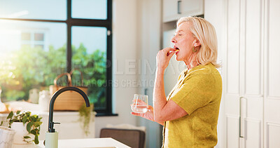 Buy stock photo Drinking, pill and woman with water, kitchen and treatment with vitamin D, calcium or health in home. Healthcare, medicine and mature person with supplements for blood pressure, wellness and liquid