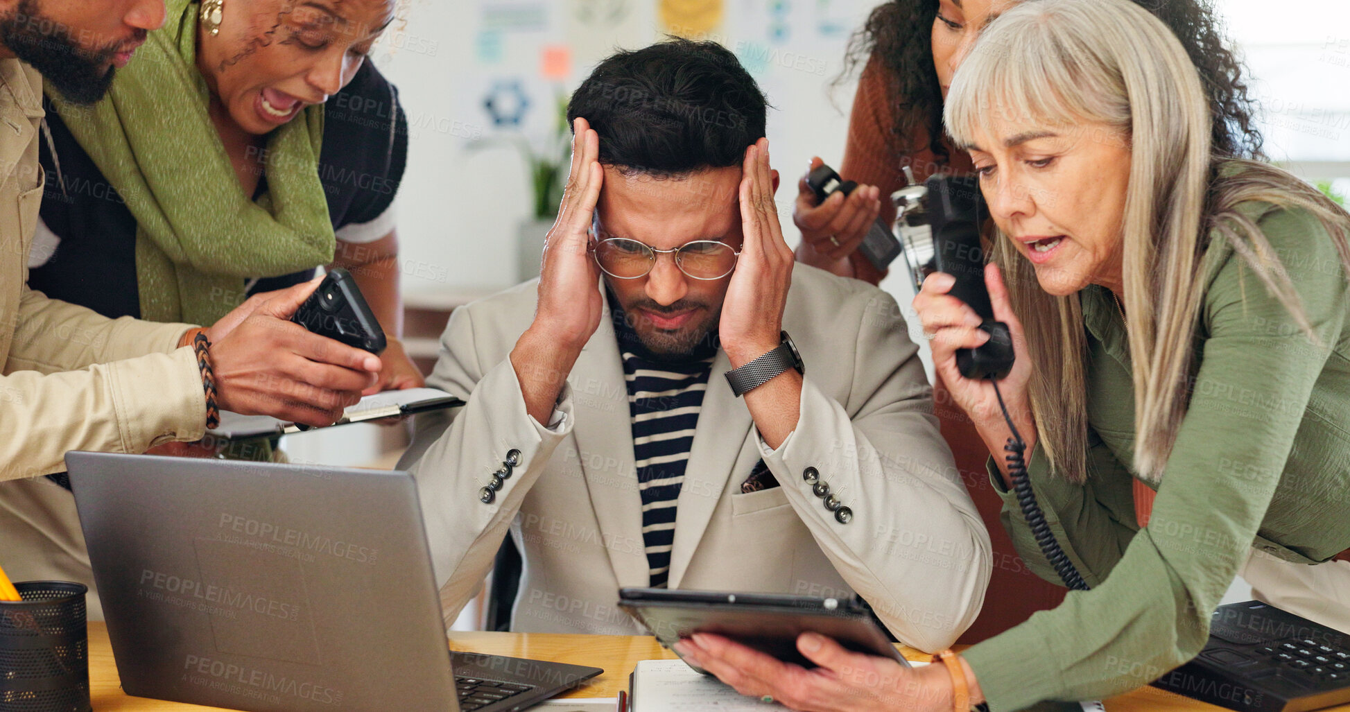 Buy stock photo Man, headache and chaos with team, overwhelmed and review for project with deadline at media company. Person, computer and crisis with stress, pain and multitasking with brain fog at creative agency