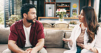 Home, angry and couple on sofa, conversation and divorce with disagreement in living room. Apartment, man or woman on couch, discussion or upset with mistake, cheating or toxic relationship with fail