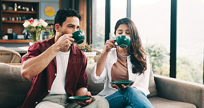Buy stock photo Couple, relax and people with coffee, lounge and chilling with hot drinks in home, break and bonding. Love, man and woman with warm beverages in living room, together and date with tea in apartment