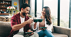 Couple, cheers and people with coffee, lounge and happy with hot drinks in house, break and bonding. Toast, man and woman with warm beverages in living room, celebration or together on couch with tea