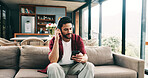 Happy man, headphones or listening with phone on sofa for audio streaming or music in home. Male person, user or smile with mobile smartphone or app for sound playlist, tune or entertainment in house