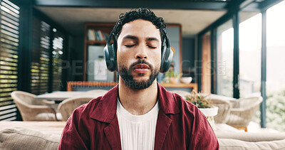 Buy stock photo Break, headphones and meditation with man on sofa in living room of home for stress relief. Audio therapy, balance and inner peace with person in apartment for mental health or wellness routine