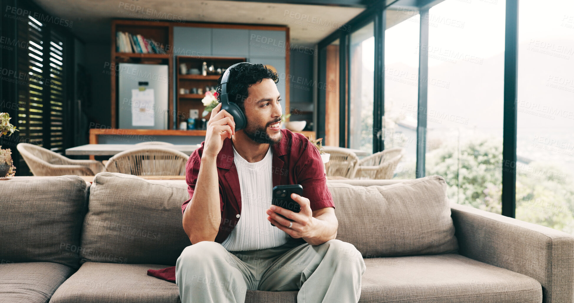 Buy stock photo Music, phone and thinking with man on sofa in living room of home for me time or wellness. App, headphones and idea with happy person in apartment for morning inspiration or weekend planning