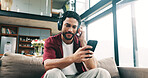 Happy man, headphones or listening with phone to music on sofa for audio streaming in home. Male person, user or smile with mobile smartphone or app for sound playlist, tune or entertainment in house