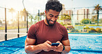 Fitness, typing and man on tennis court with phone, match schedule and social media update on rest. Padel, smile and athlete outdoor with tech, wellness chat and virtual tutorial on training break.