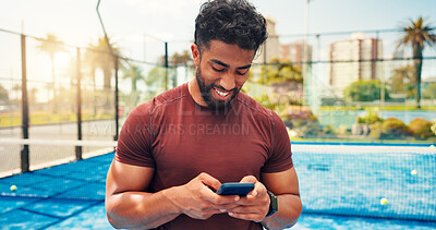 Buy stock photo Fitness, typing and man on tennis court with phone, match schedule and social media update on rest. Sport, smile and athlete outdoor with tech, wellness chat and virtual tutorial on training break.