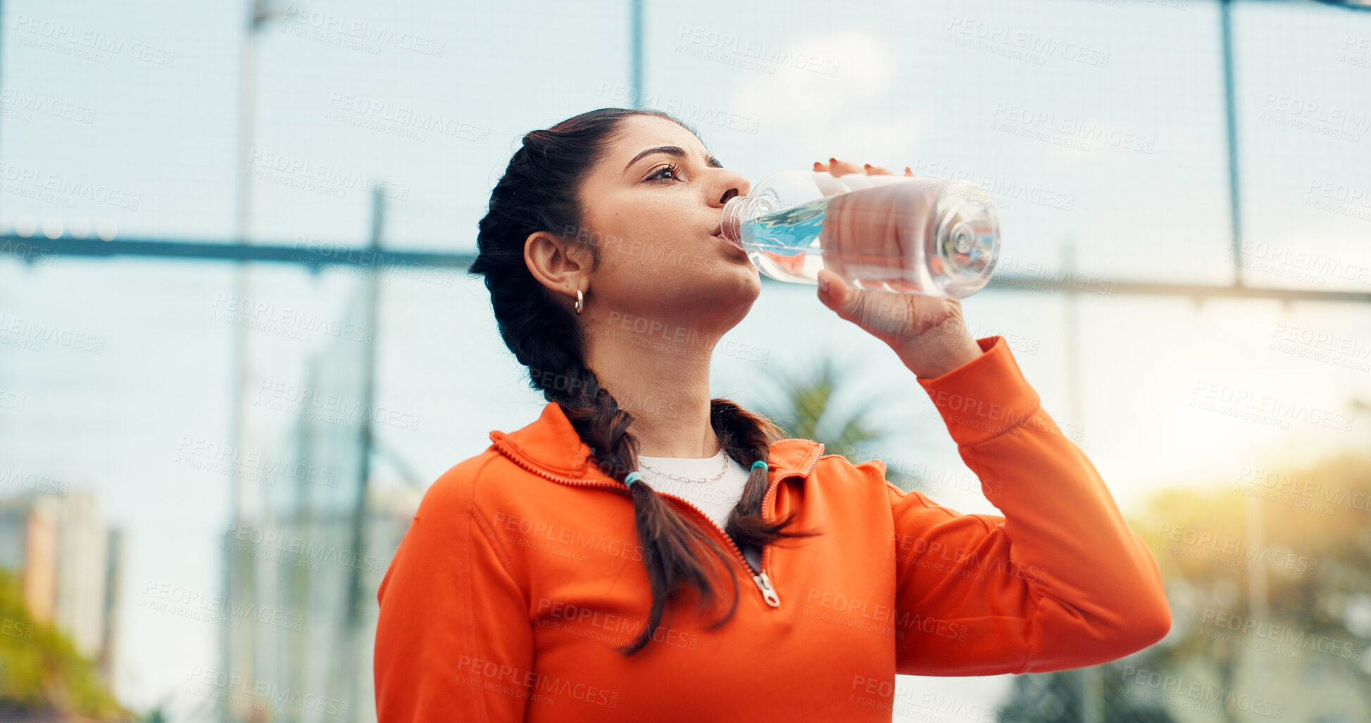 Buy stock photo Tennis player, woman outdoor or drinking water with bottle, sports hydration or competition break. Active, person or padel athlete on court with beverage for electrolytes, tournament rest or recovery