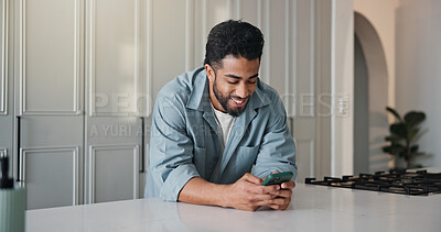 Buy stock photo Phone, happy and man in kitchen in home with networking, communication or social media on mobile app. Smile, technology and male person with cellphone for contact, texting or chatting in apartment.