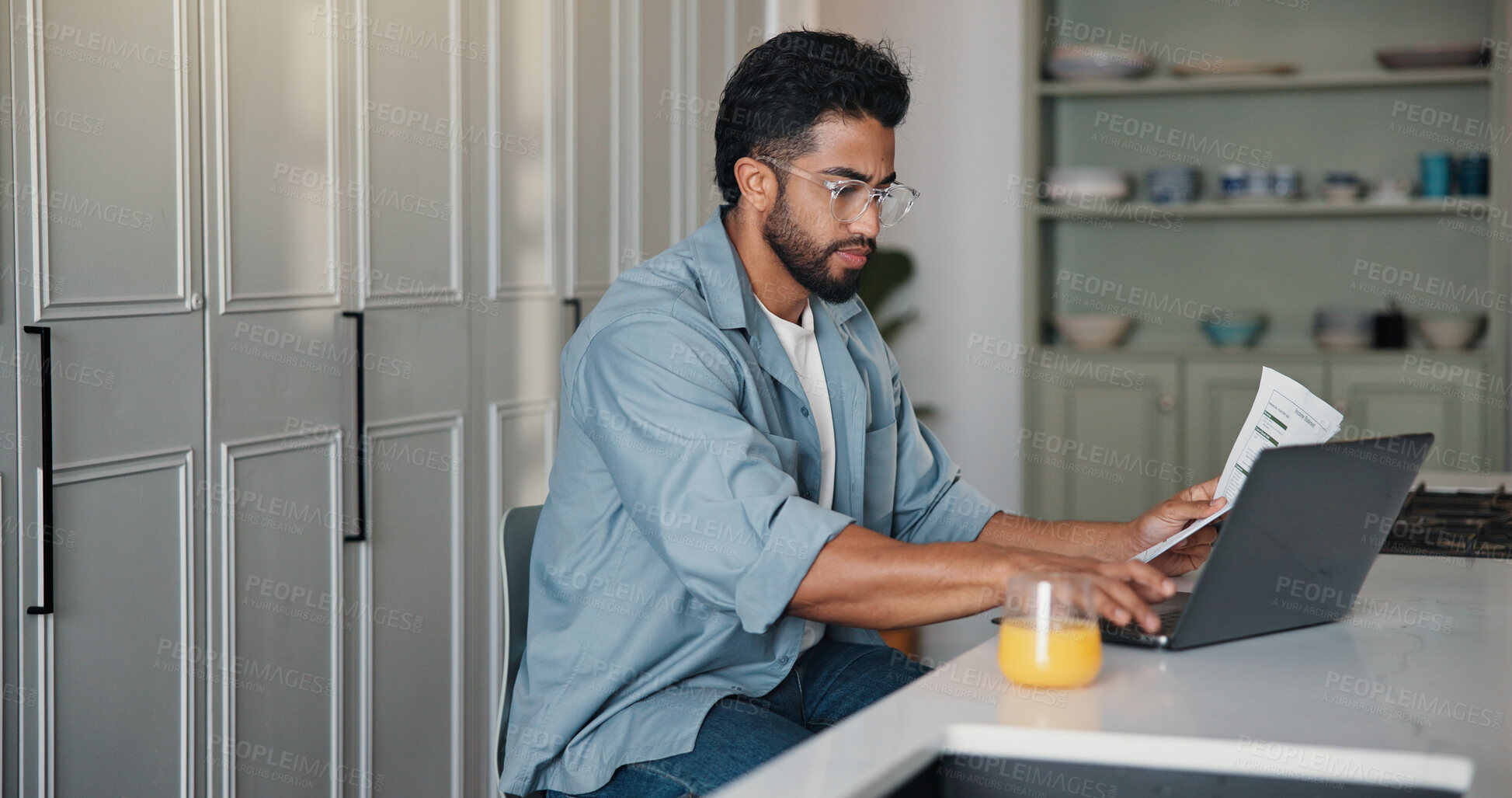 Buy stock photo Home, paperwork and man with laptop, typing and writer with royalty statement, filing or calculation. Creative, author and person with document for self employment tax, online and financial analysis