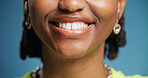 Smile, dentistry and teeth of woman in studio with oral hygiene, veneers or tooth whitening. Happy, orthodontics and mouth of person with dental care for wellness with fresh breath by blue background
