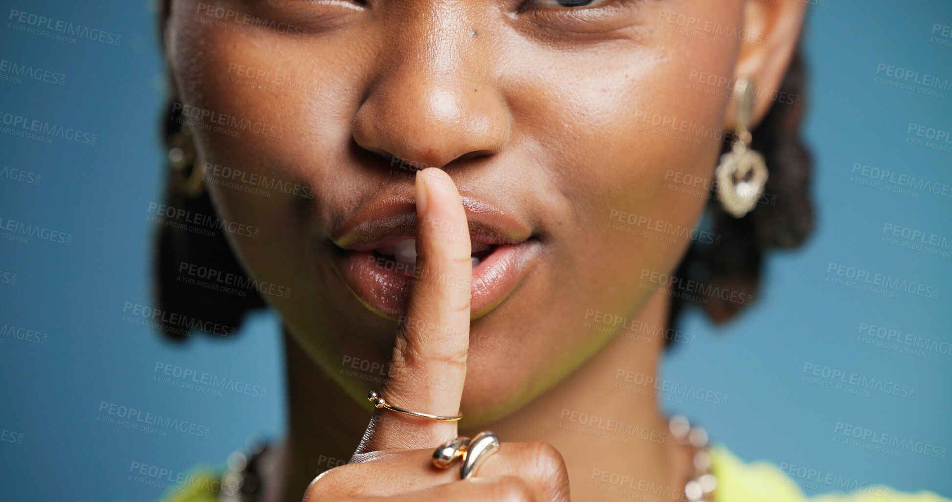 Buy stock photo Hush, mouth and secret with black woman in studio for gossip, silence or whisper gesture. Emoji, finger on lips and quiet with African person on blue background for confidential, mystery or privacy