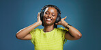 Headphones, dancing and black woman with studio background for music, listening and playlist. Happy, audio tech and African female person with smile for album, radio or song for rhythm and groove