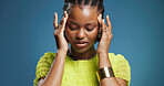 Stress, pain and black woman in studio, headache and overwhelmed on blue background. Space, migraine and African person with burnout, health risk and pressure with anxiety, tired and brain fog