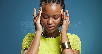 Buy stock photo Stress, pain and black woman in studio, headache and overwhelmed on blue background. Space, migraine and African person with burnout, health risk and pressure with anxiety, tired and brain fog