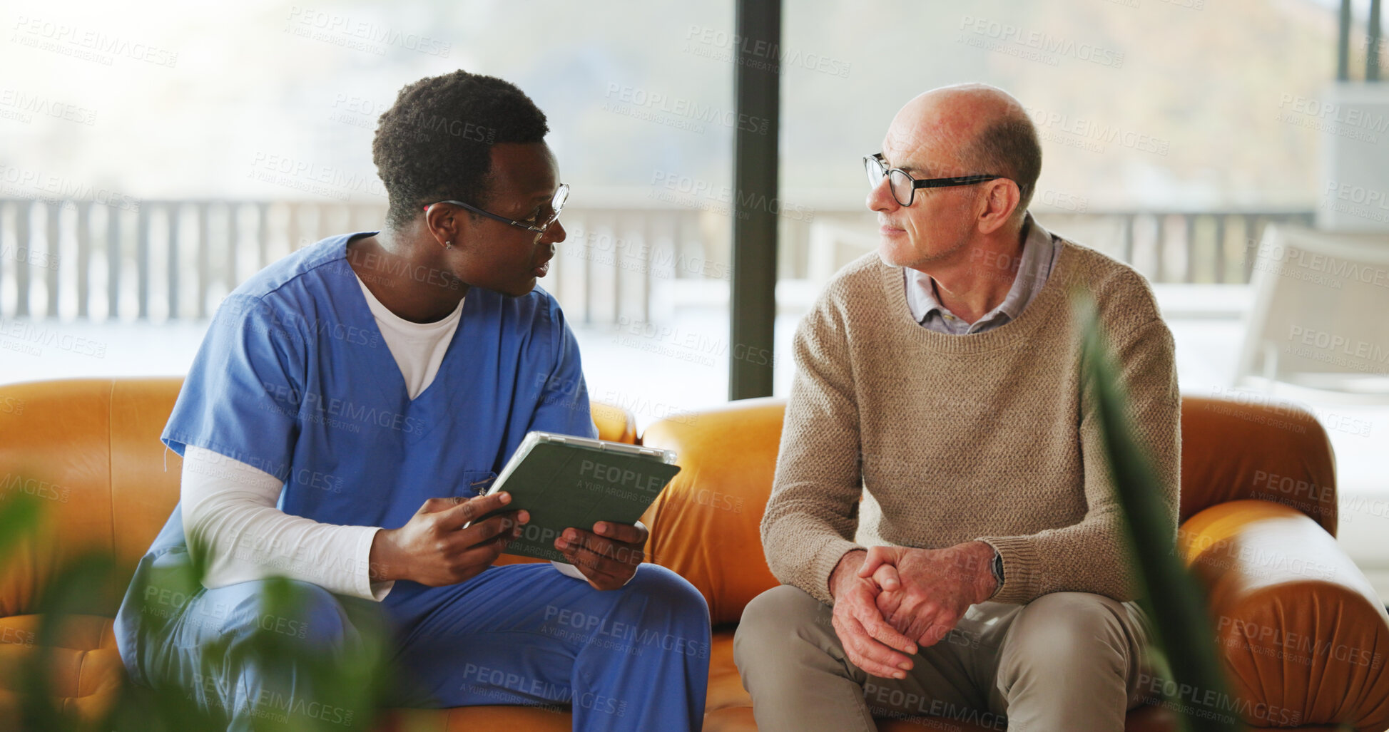 Buy stock photo Tablet, conversation and nurse with mature man on sofa in home for diagnosis, discussion or treatment plan. Technology, consultation and medical caregiver with male patient in house for research.