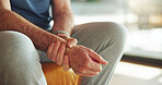Hands, wrist pain and senior person with injury, fracture or carpal tunnel syndrome with health in home. Retirement, muscle cramp or rheumatoid arthritis with pressure, fibromyalgia or sprain on sofa