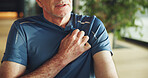 Hand, chest pain and senior man in home with emergency, hypertension or sickness in living room. Pressure, medical issue and elderly male person in retirement with heart attack symptoms in house