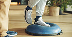 Feet, person and balance on ball for physiotherapy at house with assistance for mobility training. Physiotherapist, help and patient for stability exercise, muscle strength and rehabilitation session
