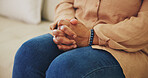 Hands, nervous and thinking with person on sofa in living room of home for anxiety or tension. Depression, psychology or worry with concerned woman in apartment for emotional stress, fear or waiting