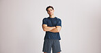 Portrait, fitness and man with arms crossed in studio for strength, exercise pride and healthy body. Mockup space, bodybuilder and confidence for training, sportswear and wellness on white background
