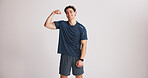 Portrait, man and flex muscle for fitness, strength and mockup space in studio. Smile, person and bodybuilder show bicep for growth, strong or confident with exercise results on white background