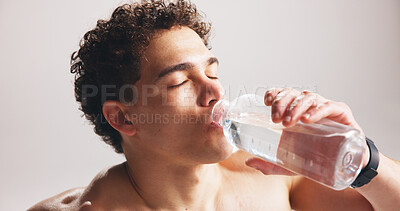 Buy stock photo Fitness, man or drinking water in studio with bottle for sports hydration, workout or exercise break. Thirsty, person or athlete with beverage for electrolytes, rest and recovery on white background.