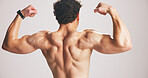 Back, man and flex muscle for fitness progress, strength and development with power in studio. Shirtless, person and bodybuilder with bicep for growth, strong or exercise results on white background